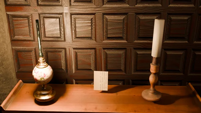The hall table: a lamp, a candle and a folded note